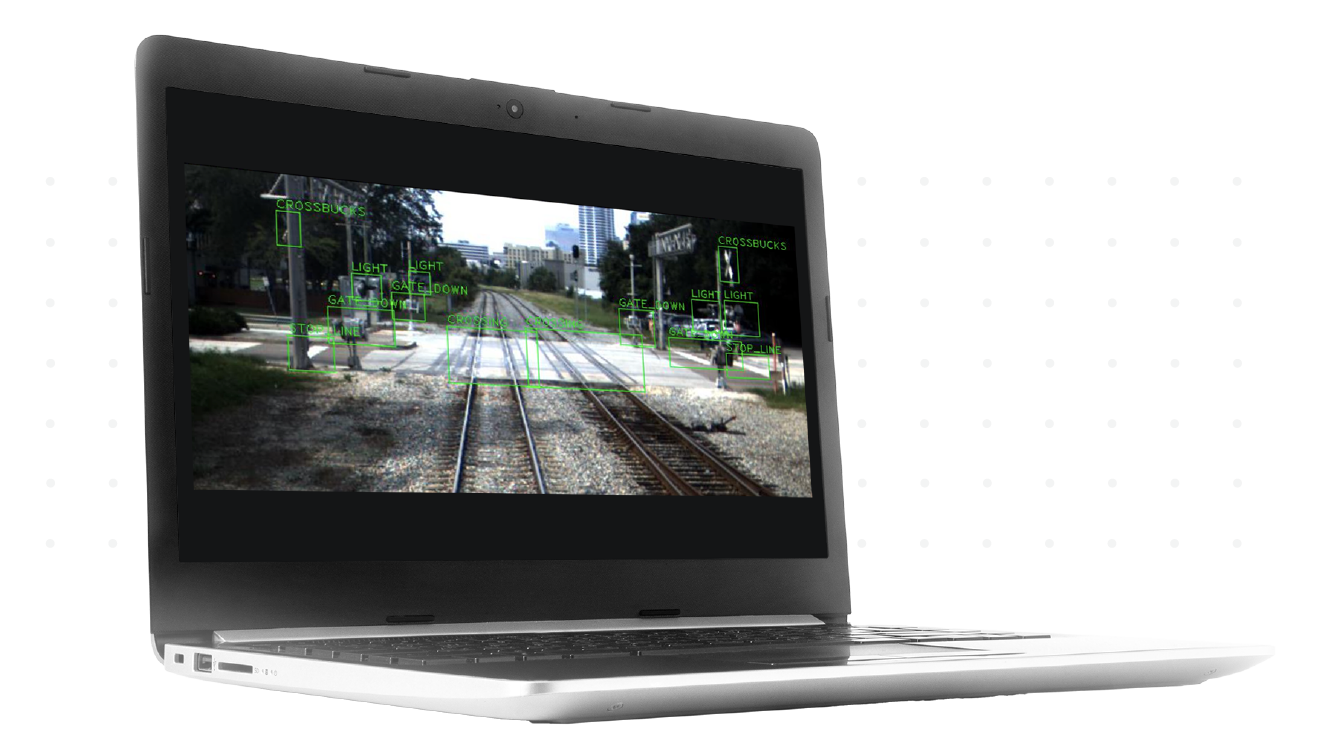 Laptop displaying forward-facing track imagery, with various components outlined and labeled
