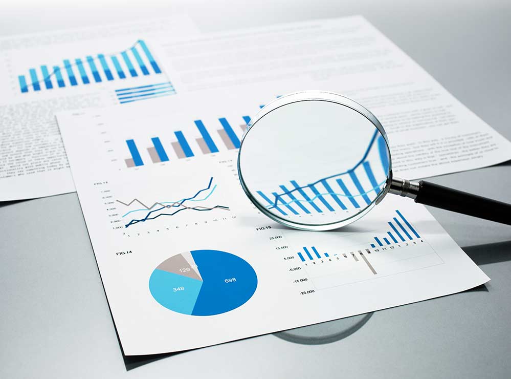 Magnifying glass focusing on printed charts